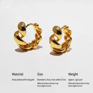 Classic golden twisted rope hoop earrings in brass with polished metallic texture