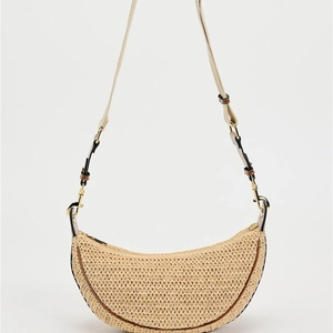 Minimalist beige raffia crescent bag with brown leather trim and gold hardware