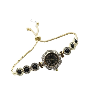 Elegant gold flower quartz bracelet watch with black dial and adjustable drawstring