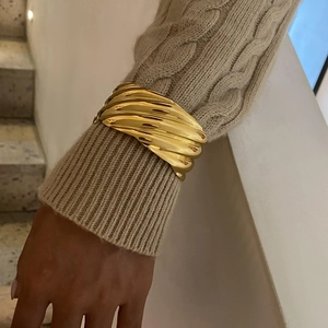 Detail showing the textured wavy 18k gold plated stainless steel wide open cuff bracelet