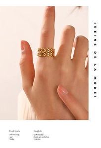 Detail of gold double-layer chain link open ring on hand with polished finish