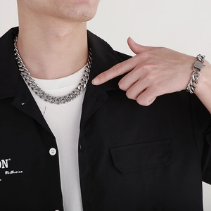 Silver stainless steel Cuban chain necklace and bracelet set worn by male model