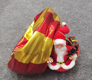 Close-up of Santa Claus plush with red and gold gift bag on a soft grey carpet