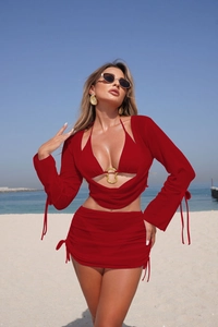 Close-up of red four-piece bikini set with golden rings and a matching beach shrug