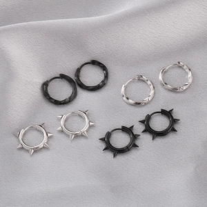 Detailed view of silver and black Mobius earrings with twist and stud textures