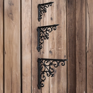 Three sizes of European vintage black cast iron shelf brackets with ornate scrollwork