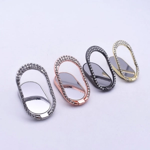 Oval diamond-encrusted metal phone ring stands in silver, rose gold, black, and gold colors