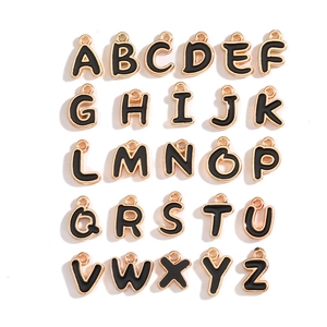 Detail of 26 double-sided black enamel and gold alloy alphabet charms for DIY jewelry making