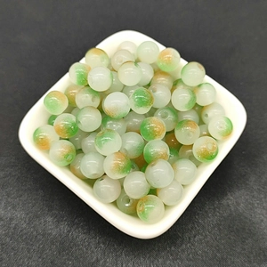 Macro shot of 8mm gradient green and orange glass beads for DIY jewelry making