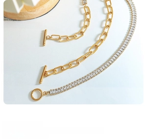 Detail of vintage gold paperclip link chain and zircon tennis necklace with OT toggle clasp