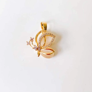 Detailed view of an 18k gold butterfly pendant with sparkling crystal inlay on wings