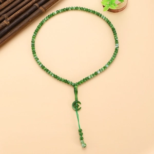 Detailed view of green Islamic Tasbih prayer beads with star moon pendant and tassel