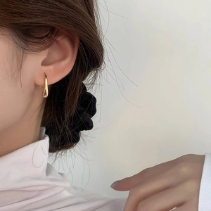 Elegant gold teardrop earrings for women in a minimalist streamlined hanging design