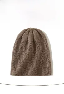 Detail of 100% cashmere knit hat showing thick cable stitch texture and soft fiber finish