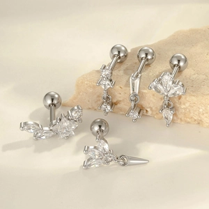 Star-shaped zircon cartilage earrings in silver-tone stainless steel set on a natural stone