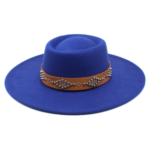 Detail of royal blue wool fedora with brown leather band and silver metal rivets decoration