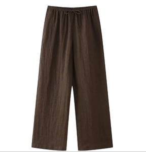 Detail of dark brown linen wide-leg pants with drawstring elastic waistband
