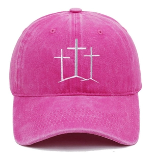 Detail of white cross embroidery on vintage washed pink cotton baseball cap
