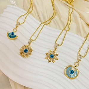 Set of 4 gold-plated necklaces featuring blue evil eye pendants in sun and star shapes
