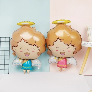 Close-up of blue and pink cartoon angel foil balloons for baby shower party decorations