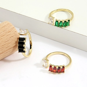 Golden adjustable open ring with colorful rectangular crystals on a tiered display