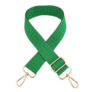 Close-up of green Greek Key jacquard bag strap with gold metal lobster clasps