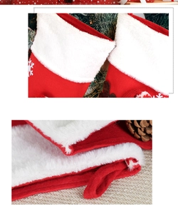 Close-up of plush red and white Christmas stocking with snowflake patterns and soft textures
