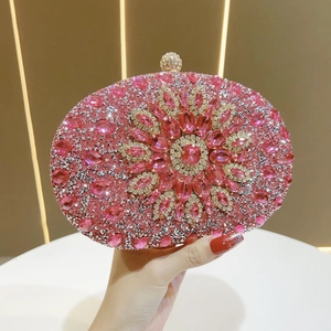 Detail of pink rhinestone evening bag with central sunflower crystal pattern