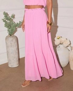 Close-up of pink pleated fabric texture on a two-piece halter top and high-waist skirt set