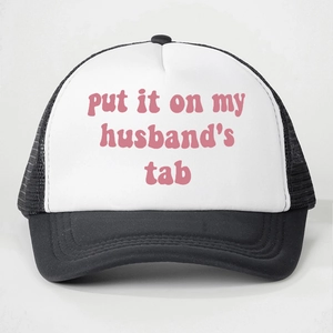 Detail of mesh baseball cap with Put It On My Husband's Tab print in pink font