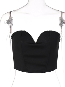 Close-up of black corset top featuring a heart-shaped neckline with silver rhinestone trim