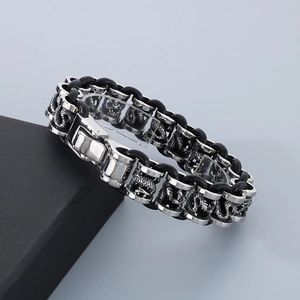 Close-up of retro punk dragon relief engraving on titanium steel and woven leather bracelet