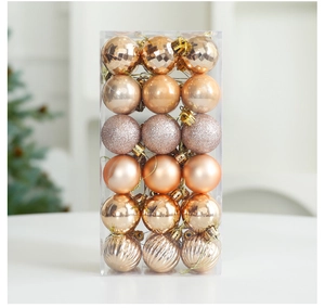 Macro detail of 36 champagne gold Christmas ornaments in a box with diverse finishes