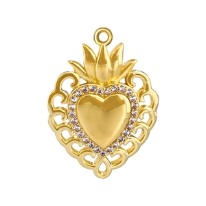 Macro shot of gold-plated heart pendant with crown detail and sparkling crystals