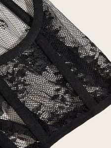 Detailed close-up of black lace fabric and fishbone corset stitching for women