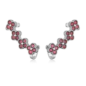Detail of silver clover ear climbers featuring sparkling pink rhinestones in curved design