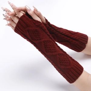 Detail of red knitted arm warmers with classic cable stitch pattern and ribbed cuffs