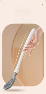 Detail of ergonomic curved handle on a silicone toilet brush with a comfortable grip