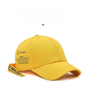 Detailed view of yellow baseball cap with long Warning Security strap and Vmade logo