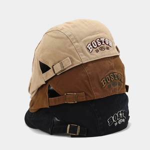 Three retro cotton newsboy hats in beige, brown and black with Boston 1985 embroidery