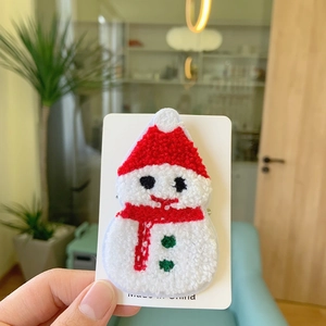 Close-up of Christmas snowman plush towel embroidery badge with soft 3D textured details