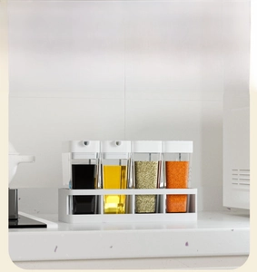 Detail presentation of kitchen seasoning set with four bottles and a white storage rack