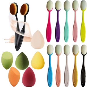 Detailed view of assorted colorful makeup sponges and a set of diverse soft contour brushes