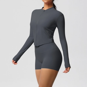 Slim fit dark grey yoga set featuring a zip-up long sleeve jacket and high waist shorts