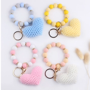 Detail view of 4-piece set featuring crochet hearts and silicone beaded wristlet keychains