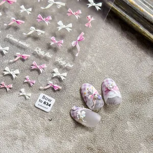 Detail of 3D relief nail stickers featuring pink and white bows with elegant textures