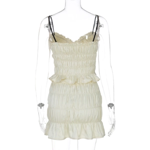 Detail view of beige pleated mini dress back showing ruffled waist and hemline