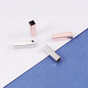 Macro shot of mirror polished stainless steel hollow rectangle tubes in silver and rose gold