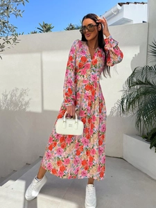 Detail of pink floral V-neck long sleeve dress with waist tie and button-down front