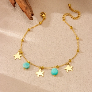 Gold starfish anklet with mint green stone beads and adjustable chain on a beige background